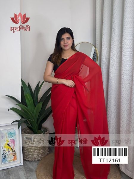A woman wearing a red saree and black blouse stands indoors near a green plant, a floor lamp, and a framed bicycle artwork. The logo and text सुपर्ण्लिनी and a barcode appear on the image.