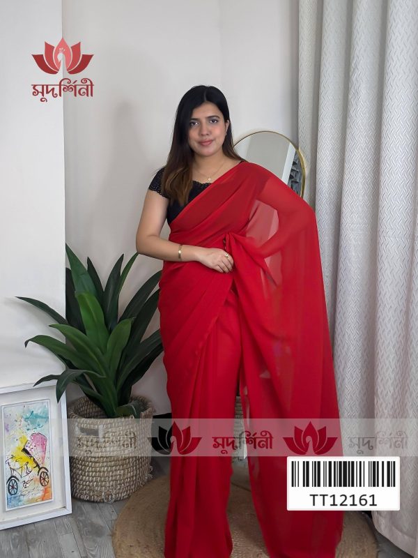A woman wearing a red saree and black blouse stands indoors near a green plant, a floor lamp, and a framed bicycle artwork. The logo and text सुपर्ण्लिनी and a barcode appear on the image. A woman wearing a red saree and black blouse stands indoors near a green plant, a floor lamp, and a framed bicycle artwork. The logo and text सुपर्ण्लिनी and a barcode appear on the image.